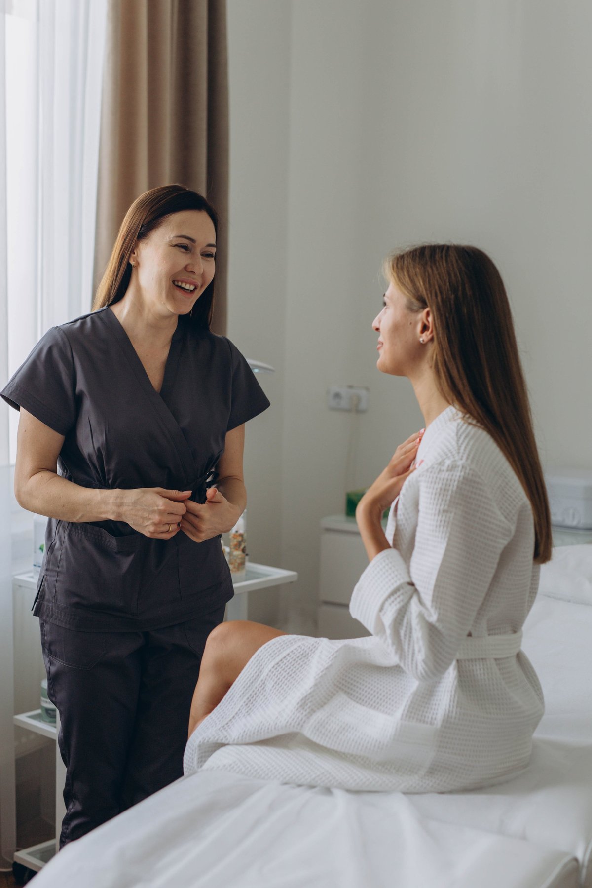 Consultation in cosmetology clinic. Female beauty doctor talking with patient